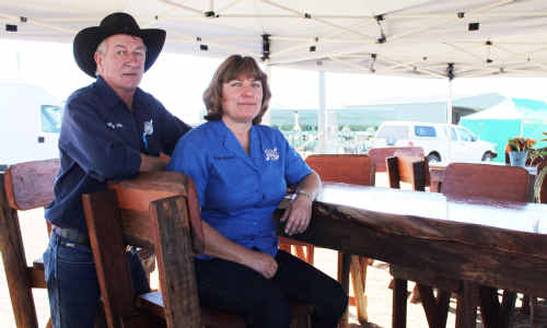 Wayne and Leesa Harding sit at one of the table settings they made from recycled timber. Wayne and Leesa Harding sit at one of the table settings they made from recycled timber.